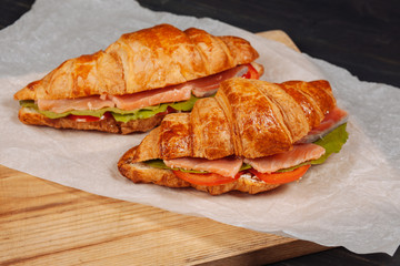Delisious croissants with salmon served on the paper