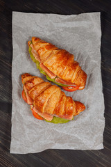 Top view of tatsy croissants with salmon