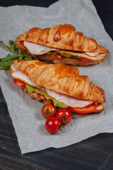 Close up of tasty croissants with ham on the table