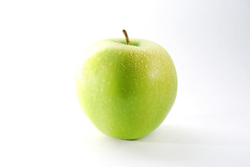 Green apple with water drops on the white background
