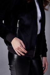 Detail of clothes jacket black color lather pants manicure cream for skin care beauty salon spa jewelry accessory.