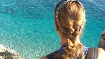 a girl explores the Zingaro nature reserve on Sicily island in Italy