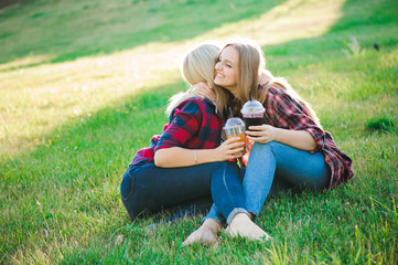 Fototapeta premium Young Girlfriends Hugging at the Park