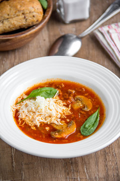 Italian soup with tomatoes, mushrooms, minced meat, cheese, vegetables