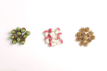 Christmas (New Year) ornaments in the form of cones, acorns and mushrooms on a white background. Simple flat lay composition.
