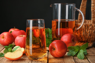 Glass with fresh apple juice on wooden table