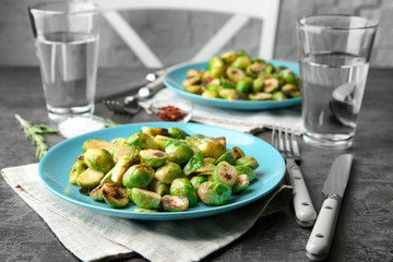 Plate with roasted brussel sprouts on table