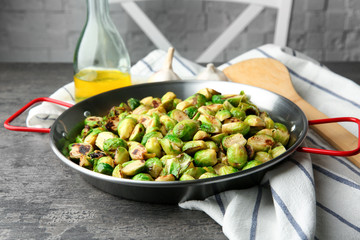 Frying pan with roasted brussel sprouts on table