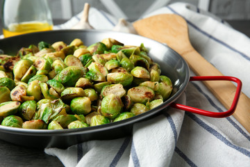 Frying pan with roasted brussel sprouts on table