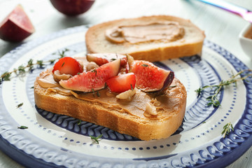 Fresh toast with peanut butter, fig and strawberry on stand