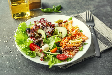 Plate with fresh vegetable salad on table