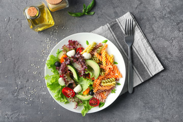 Plate with fresh vegetable salad on table