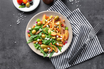 Plate with fresh vegetable salad on table