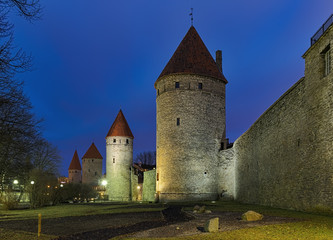 Fototapeta na wymiar Towers of Tallinn City Wall in dusk, Estonia. From right to left: Rope Hill Tower (Koismae torn), Plate Tower (Plate torn), Epping Tower (Eppingi torn), Tower behind Grusbeke (Grusbeke-tagune torn).