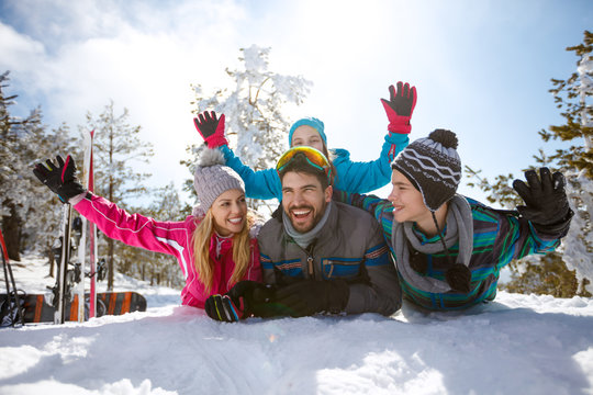 Cheerful parents with children on snow