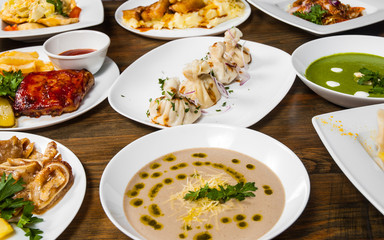 dishes with different food on the wooden table.