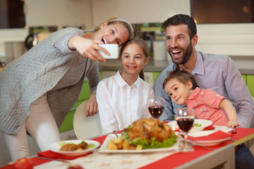 happy family taking photo with mobile phone for Christmas.