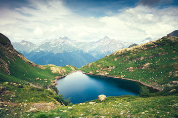Naklejka na ściany i meble Landscape of beautiful Lake with Rocky Mountains Summer Travel serene aerial view