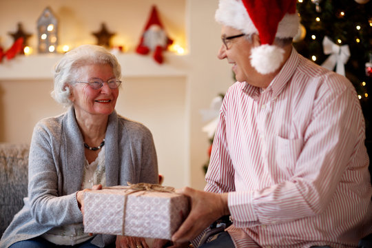 senior couple with presents spending Christmas together.
