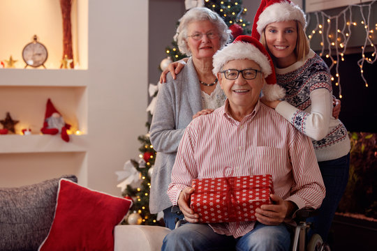 Christmas family portrait of daughter with elderly parents.