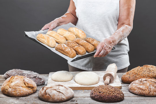 Baker preparing delicious fresh bread and pastry