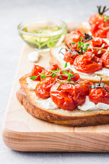 Roasted tomato garlic ricotta cheese appetizer. Selective focus, close up.
