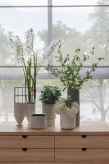 plants in vase on wooden table side