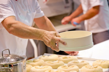 Cooking hotcakes on the kitchen, man hands with fresh dough