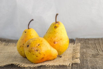 Tasty, juicy, ripe, yellow pears on a rustic background on a wooden table and a white background.