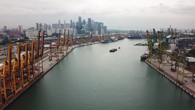 Singapore. November 21, 2017: Aerial drone view of Singapore container port with cranes, containers, and city skyline. Shot in 4k resolution