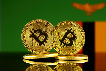 Physical version of Bitcoin and Zambia Flag. Close up.
