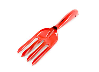 red garden fork on white background