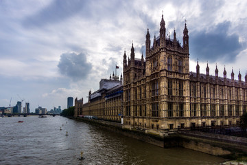 Fototapeta na wymiar Palace of Westminster, Dramatic Shot over River Thames in front of Moody Clouds