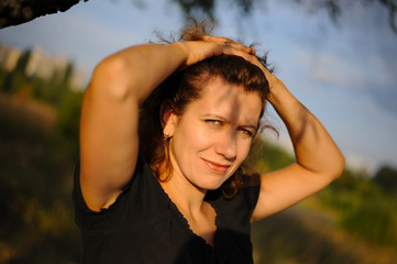 Portrait of a cute middle-aged woman. She is resting in the park