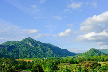 Fototapeta na wymiar mountains green grass and blue sky landscape in Thailand.- (Selective focus)
