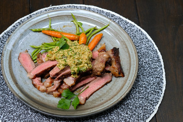 Close up Steak with Green Olive Pesto. (selective focus)