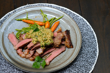 Close up Steak with Green Olive Pesto. (selective focus)