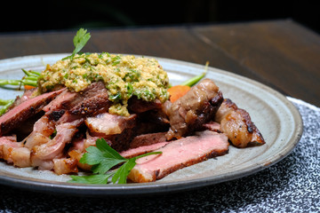 Close up Steak with Green Olive Pesto. (selective focus)