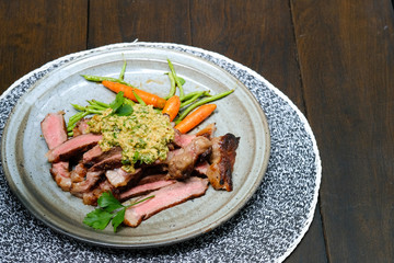 Close up Steak with Green Olive Pesto. (selective focus)