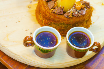 two cups of coffee with caramel pear cake