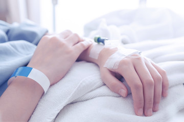 female patient sleeping on the patient bed in the room after surgery at the hospital with sunbeem.