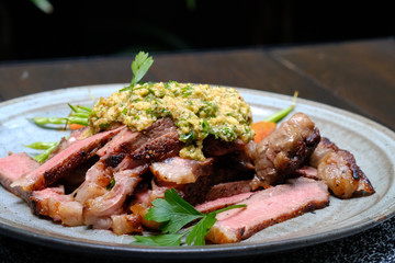 Close up Steak with Green Olive Pesto. (selective focus)