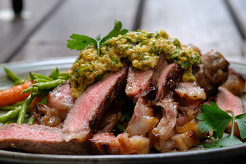 Close up Steak with Green Olive Pesto. (selective focus)