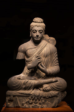 ancient seated Buddha schist statue image in 2nd-3rd century, kushan dynasty from Pakistan.