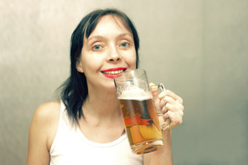 Beautiful woman is drinking beer.