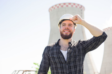 Portrait of a beautiful engineer at work with the phone