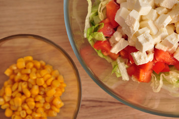 Sliced salad of corn and cabbage with tomato and feta cheese