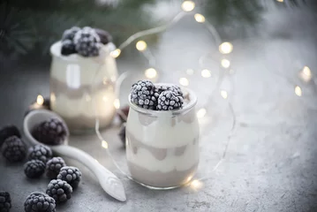 Fototapeten winter milk dessert with frozen blackberry  © tyosya