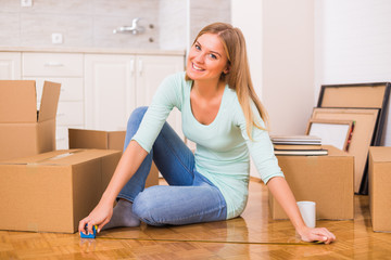 Beautiful woman moving into new home and measuring.