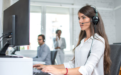 Portrait of female customer support operator working in call center. Help and technical support...